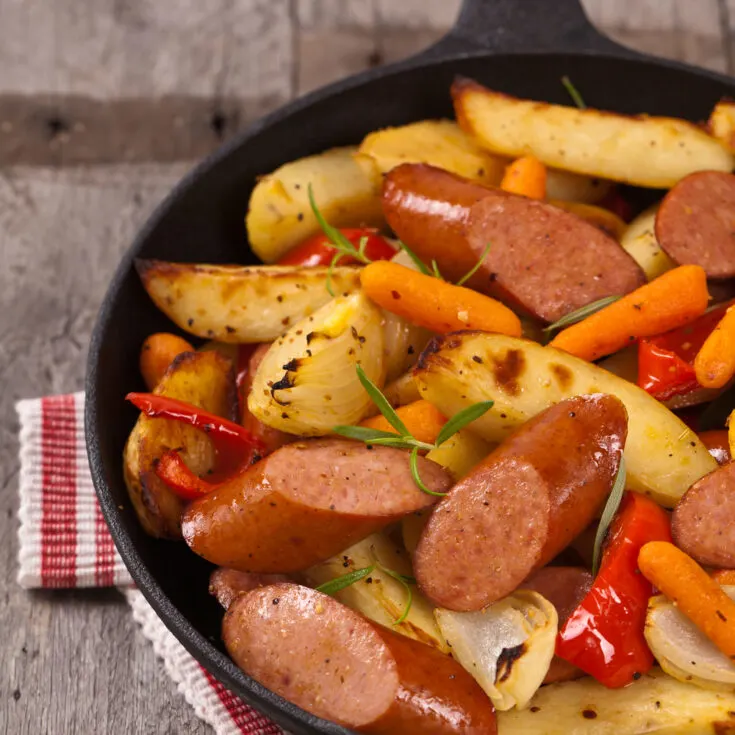 Sausage in a frying pan with vegetables. 