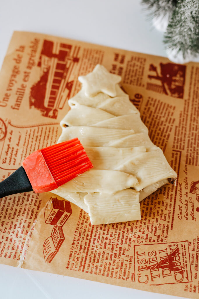 Brushing the puff pastry tree with butter