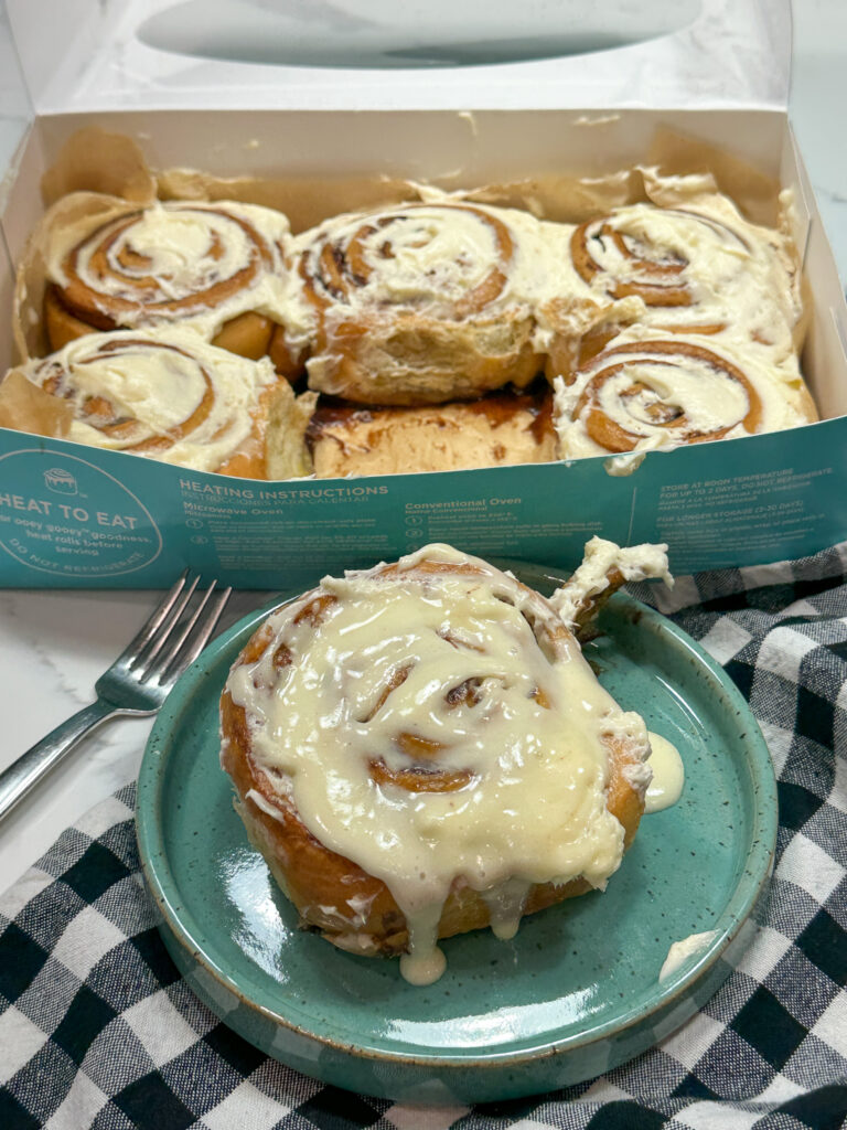 Cinnamon rolls on a plate and in a box. 