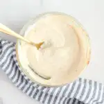 Ranch sauce in a small bowl with a spoon.
