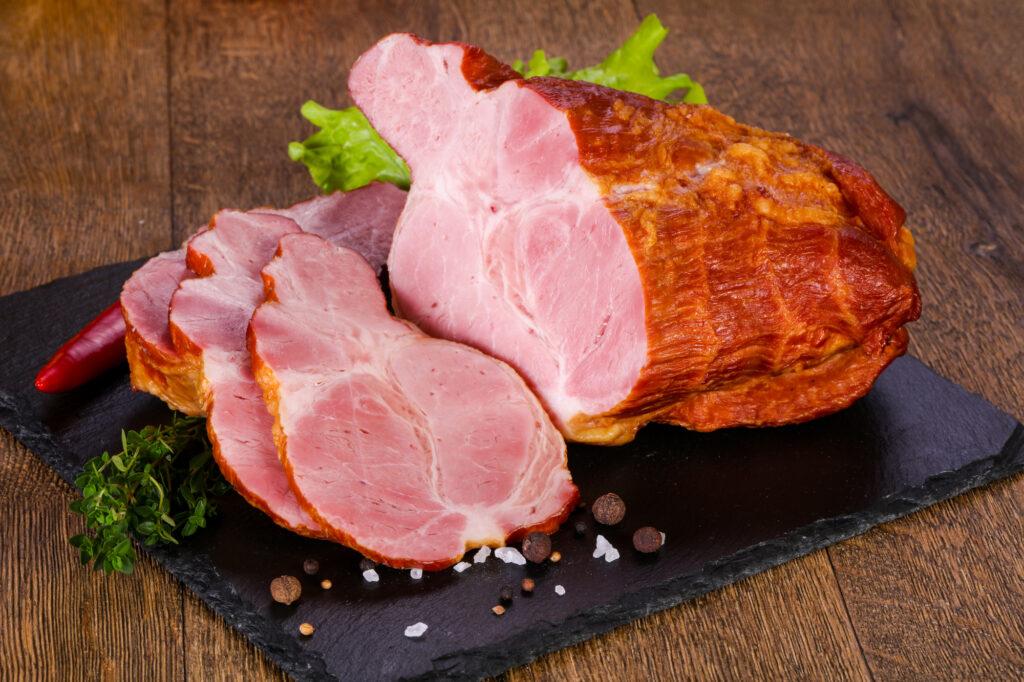 Smoked pork meat over the wooden background