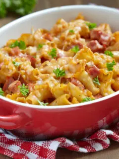 pasta casserole with cheese and ham with tomato and cream sauce