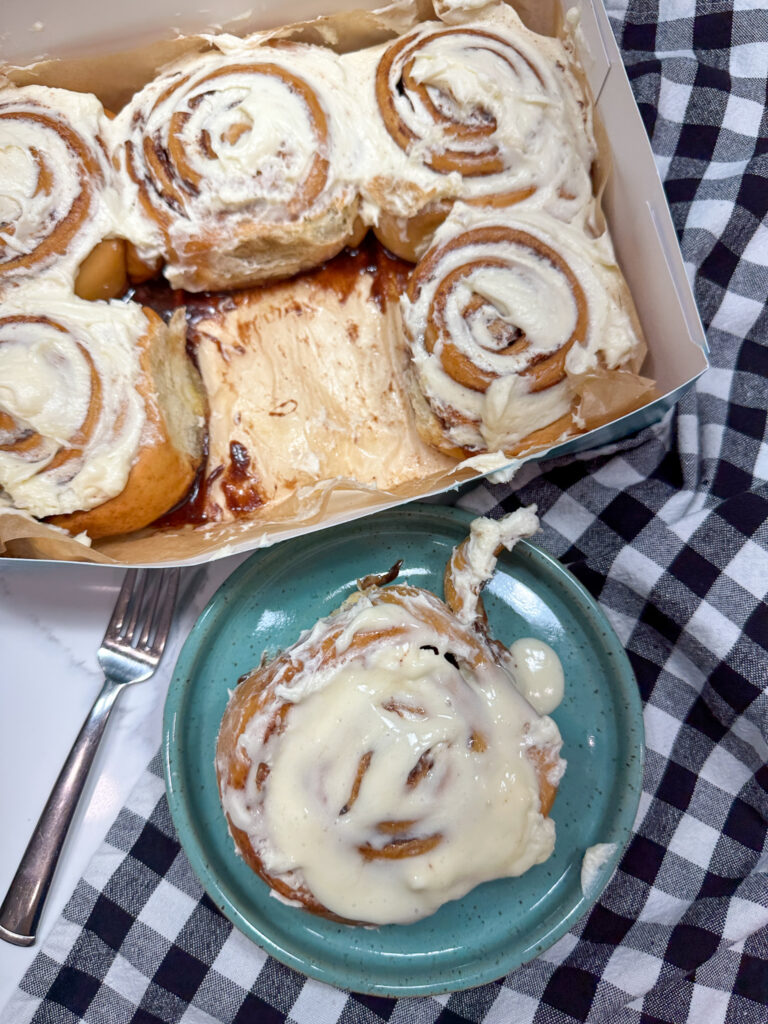 Cinnamon rolls in a box and on a green plate. 