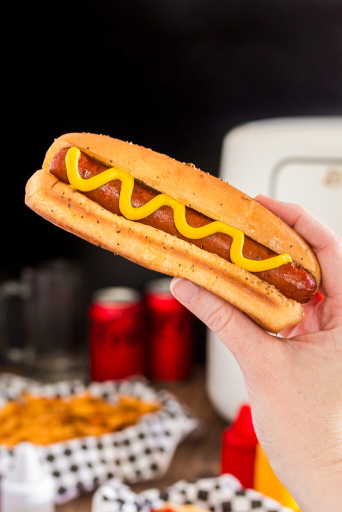 Air fryer hot dog being held. 