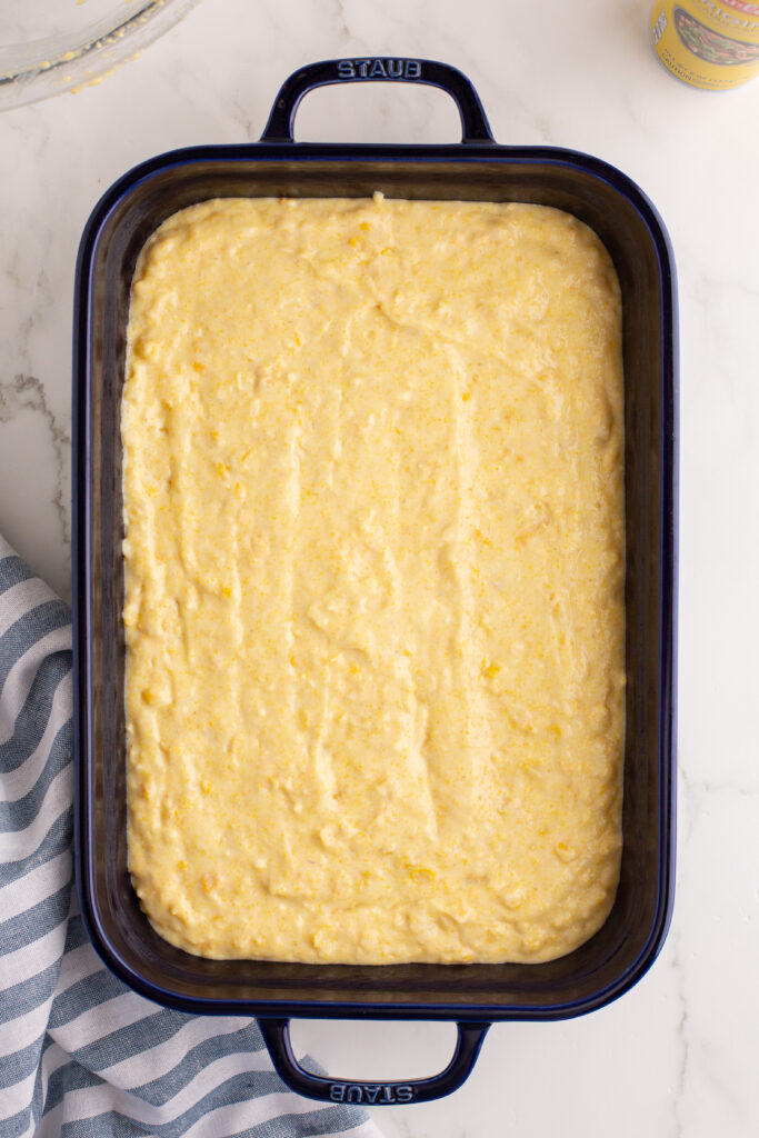 uncooked cornbread in a baking dish.