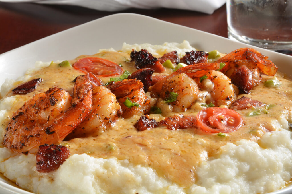 Sauteed shrimp, onions,  tri color peppers with sausage, creole butter, on grits