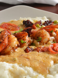 Sauteed shrimp, onions, tri color peppers with sausage, creole butter, on grits
