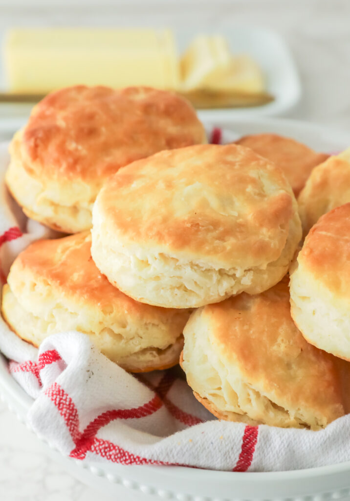 Buttermilk biscuits stacked on a plate. 