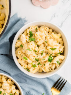 Creamy mac and cheese in a white bowl.